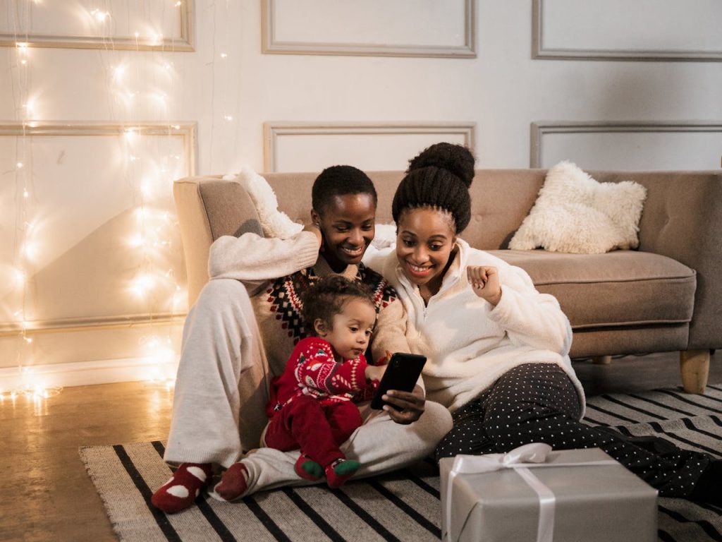 pexels-photo-5970803 A joyful family gathers indoors for a holiday video call, embracing technology and togetherness.